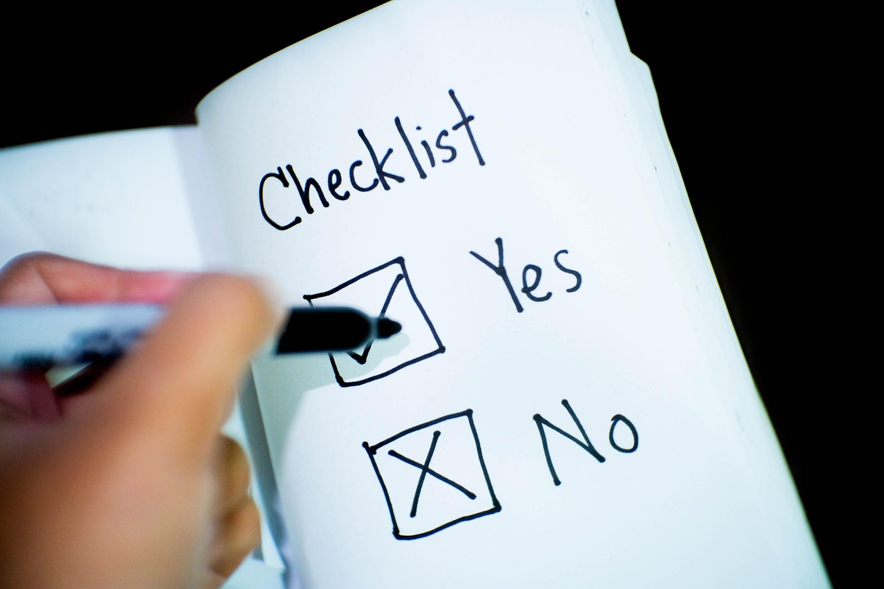 A hand ticking a hand-drawn checklist