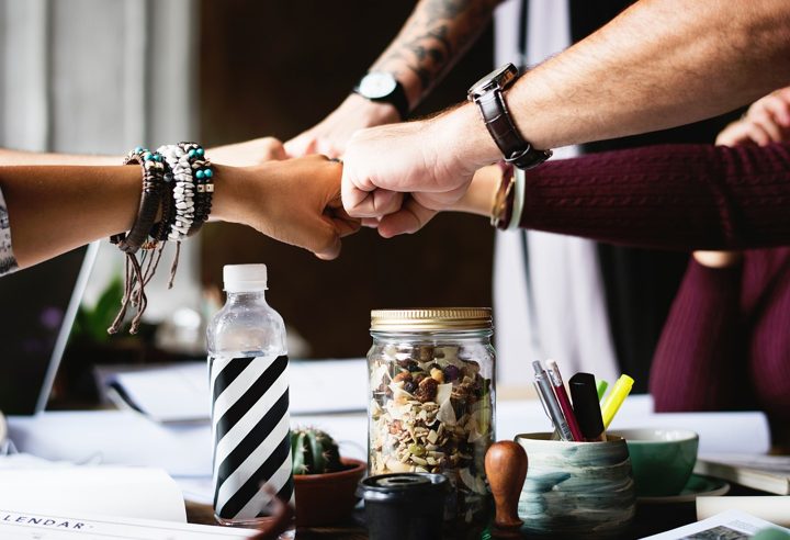 Hands coming together in a group fist bump
